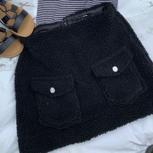 Black fuzzy skirt.